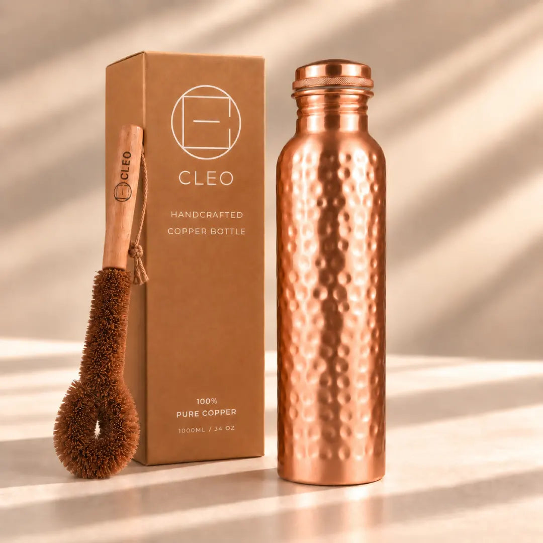 CLEO 34 oz handcrafted hammered copper water bottle with cleaning brush and branded product box.