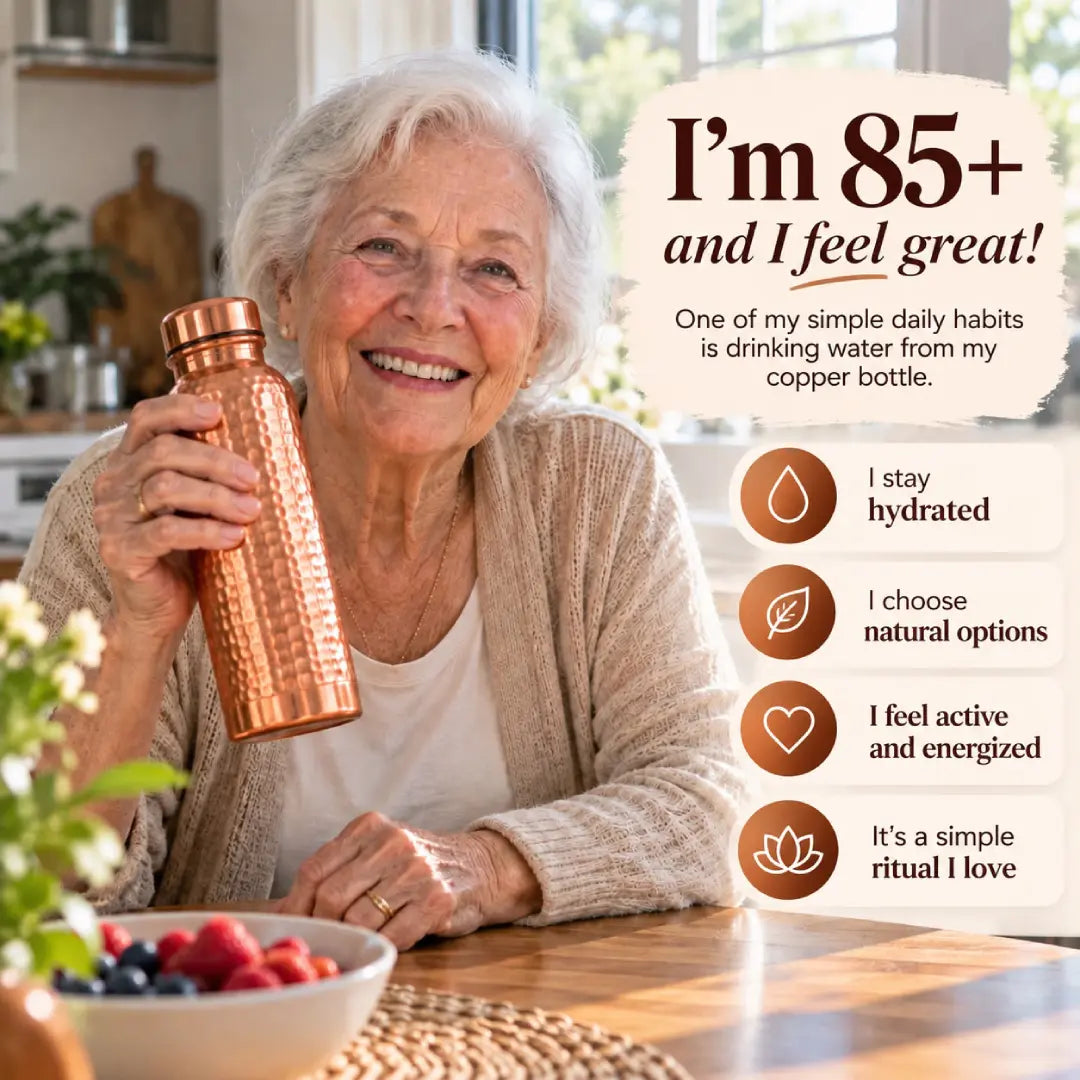 Smiling older woman holding a hammered copper water bottle at home, highlighting hydration and a simple daily wellness ritual.